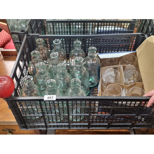 497 - A collection of glassware including 12 700ml Roe & Co. Irish Whiskey bottles. Along with a set of si... 