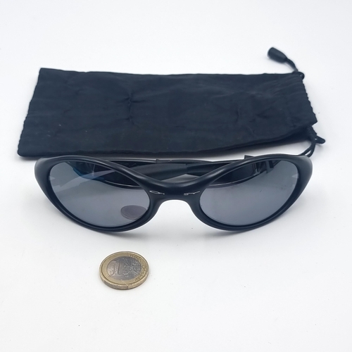 501 - A pair of high quality designer Oakley wrap around gentleman's sunglasses. Lenses in good condition.... 