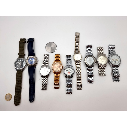 537 - A large collection of nine wrist watches, seven of which have metal bracelets. Together with a Sekon... 