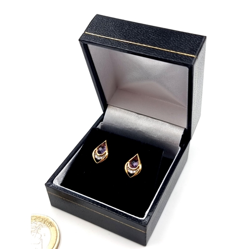 548 - A pair of 9 carat gold plated Amethyst and White Sapphire stone stud earrings.