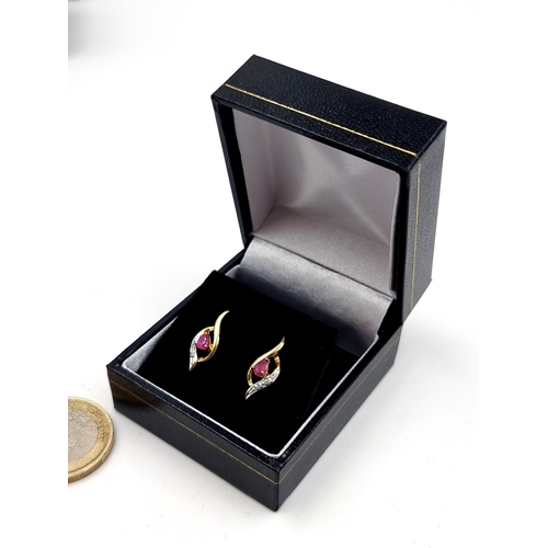 550 - An exquisite pair of 9 carat gold Ruby and White Sapphire stud earrings, featuring a beautiful abstr... 