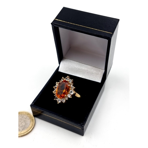 551 - A show stopping and unusual Orange Topaz stone ring, set beautifully with an array of White Sapphire... 