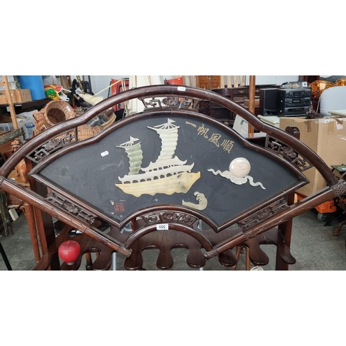 559 - A large Chinese carved cherry wood wall hanging. Carved in a fan shape with a soapstone junk ship to... 