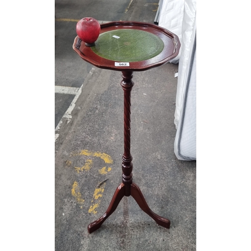 562 - A tall floor standing wine table with green leather lined top with scalloped edge, turned wood pilla... 