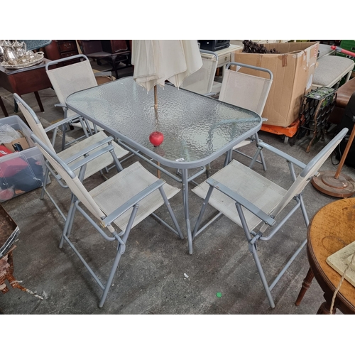 567 - A  garden dining suite with 6 folding deck chairs and a tempered glass table, complete with matching... 