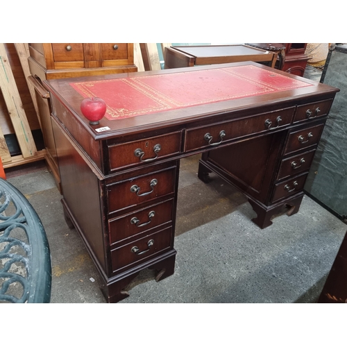 578 - Star Lot : A handsome wooden antique style desk with nine drawers with drop pull handles and topped ... 