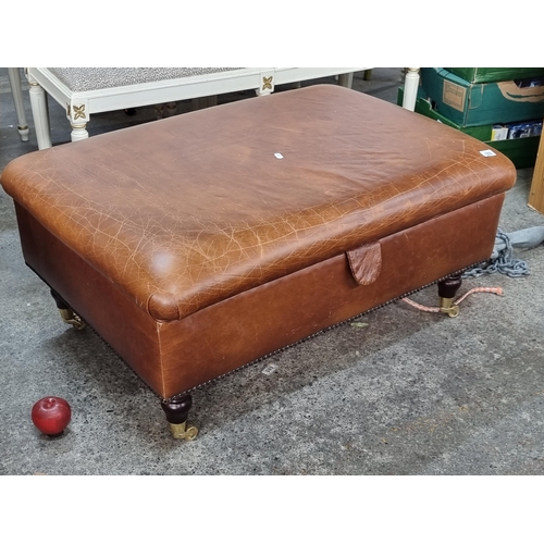 589 - A very large and handsome foot stool with brown leather top with brass stud detail, held on turned w... 