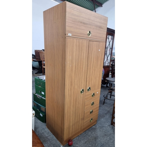 600 - A fabulous mid century  wardrobe with a super retro aesthetic. Featuring a myriad of storage compart... 