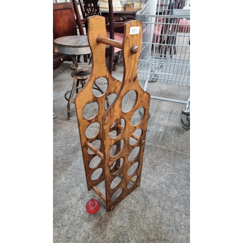 601 - A tall wooden wine holder in the form of a bottle with space for 11 bottles.