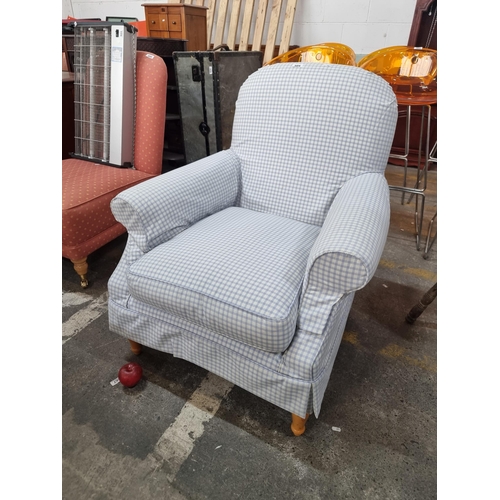 604 - A nice example of a very comfortable arm chair with tartan blue and white upholstery and held on woo... 