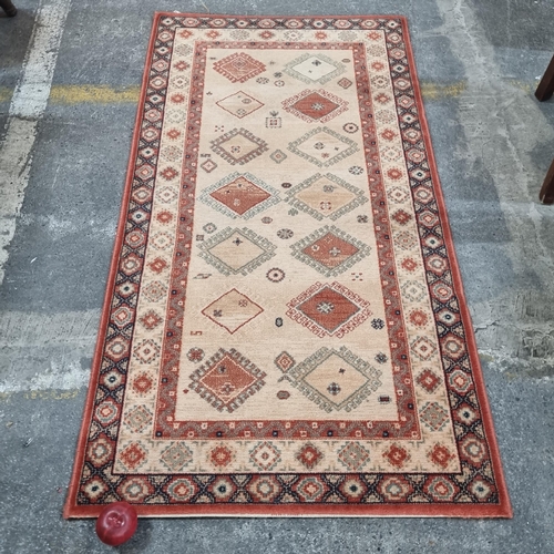 620 - An attractive contemporary floor rug in an Oriental style sporting many of the traditional motifs su... 