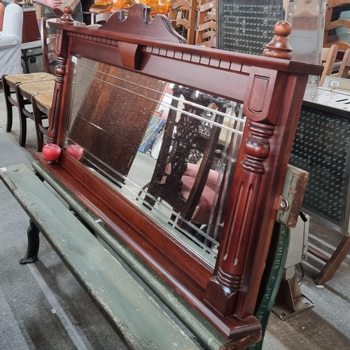 622 - A large over-mantle mirror housed in a heavy wood frame. With bevelled glass pane to centre and reed... 