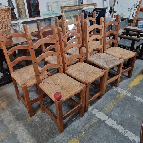 627 - Star Lot : A set of eight heavy wooden ladderback dining chairs with woven sugán seats. Featuring cu... 