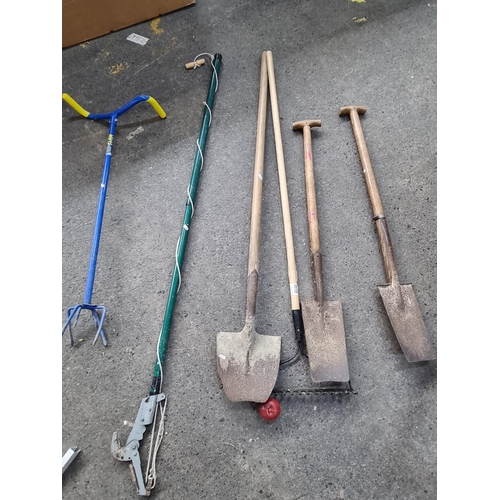 651 - A selection of six long handled garden tools.  Included are two spades, a shovel and a long handled ... 