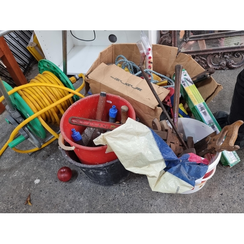 654 - A HoZeLock garden hose reel with a large quanity of mixed tools including spanners chisels, a German... 