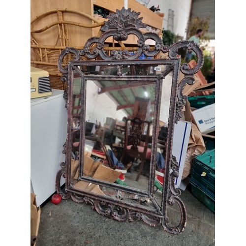 656 - A highly ornate large vintage compartment mirror housed in an elaborate antique style frame with C s... 