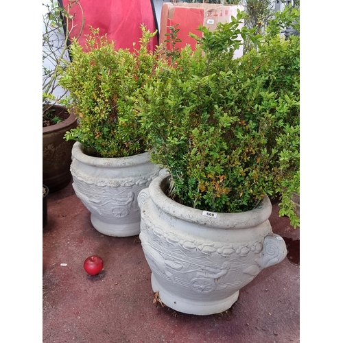 660 - Two large reconstituted stone planters  with relief scenes of Roman charioteers and a border of fuch... 