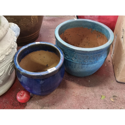 663 - Two large and heavy terracotta planters with navy and sky blue glaze finishes. H29cm and H24cm