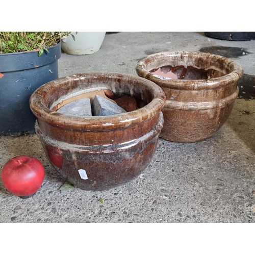 686 - A pair of stylish glazed terracotta planters in an attractive brown speckle glaze. Along with a coll... 