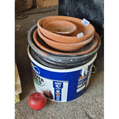 707 - A selection of terracotta and stone garden items including 8 planter saucers and a bucket full of ap... 