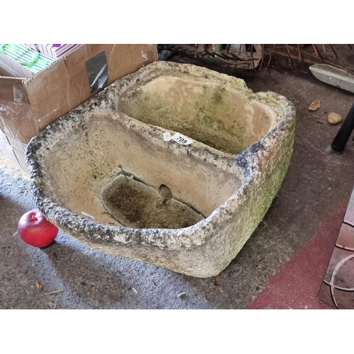 709 - A very heavy reconstituted stone garden planter/birdbath with two compartments connected by a hole t... 