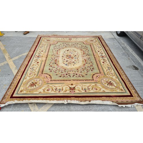 185 - Star Lot : A very large and high quality woolen rug in shades of reds, browns, pinks and greens.  Ve... 