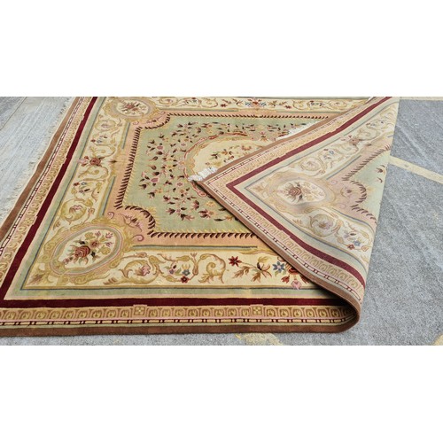 185 - Star Lot : A very large and high quality woolen rug in shades of reds, browns, pinks and greens.  Ve... 