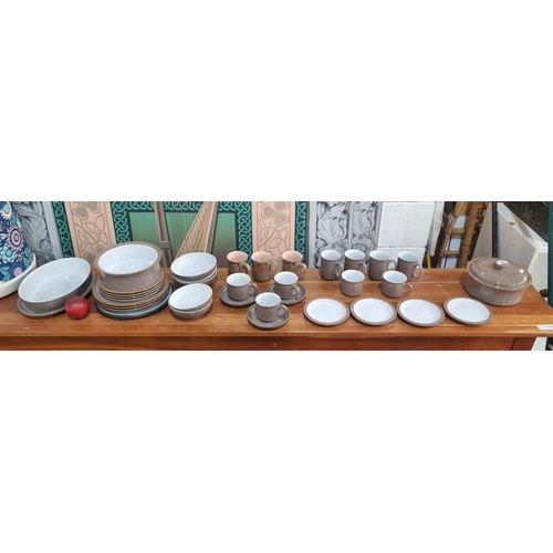 594 - A great lot of thirty six pieces of Denby pottery in a warm taupe shade. This is a mixed lot of well... 