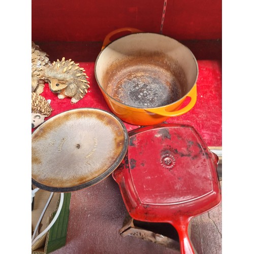 274 - A large enameled cast iron casserole dish made by Cousances, in vibrant graduated shades of orange a... 