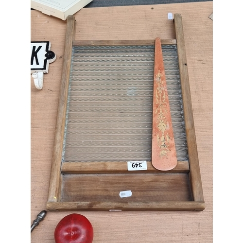 349 - A vintage washboard with a glass ribbed panel and wooden frame.