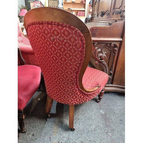 443 - A wonderful antique mahogany ladies fireside chair boasting a lovely cushioned spoon back, serpentin... 