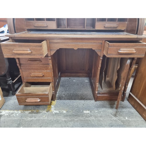 496 - Star Lot - A striking antique solid oak writing desk with a drop down shutter to top to reveal nine ... 