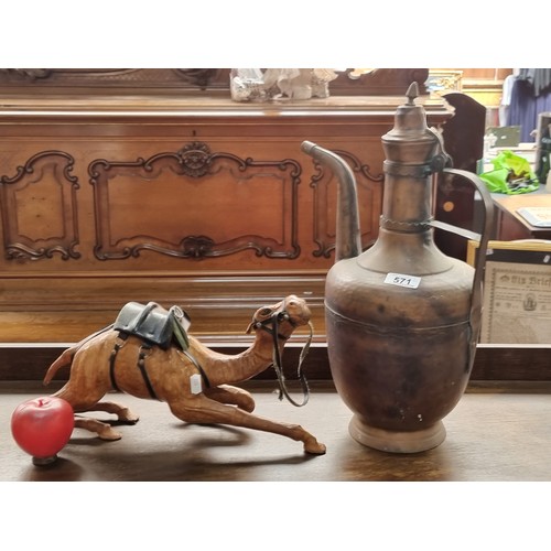 571 - Two items including a hand made leather bound camel figure and a large copper oil jug.