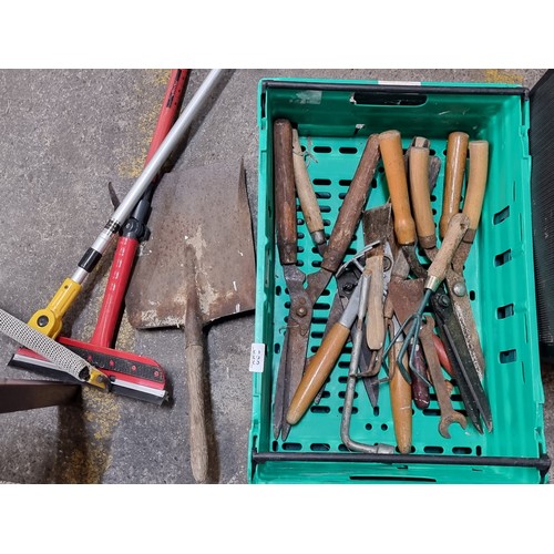 588 - A crate  filled with DIY and Gardening tools, including snippers, secretaires, trowels and more.