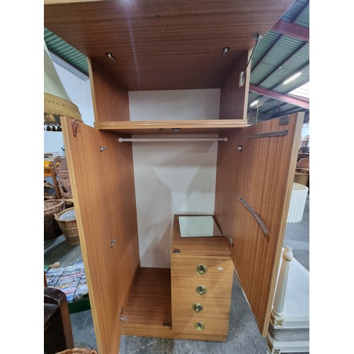 600 - A fabulous mid century  wardrobe with a super retro aesthetic. Featuring a myriad of storage compart... 