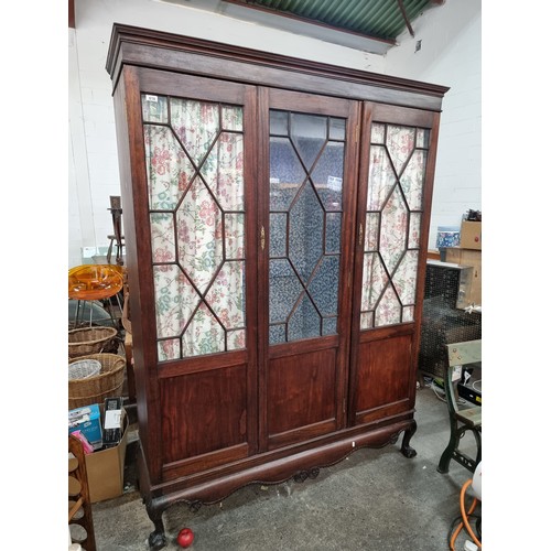 618 - Star Lot : A handsome Victorian mahogany triple wood wardrobe. An unusual glaze fronted example with... 