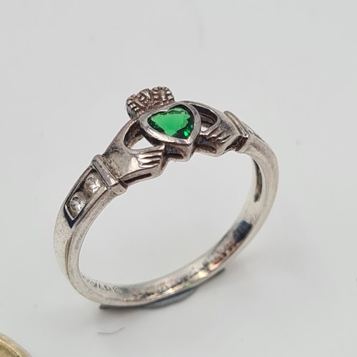 513 - An attractive example of a sterling silver hallmarked Claddagh ring, set with a bright May birth sto... 