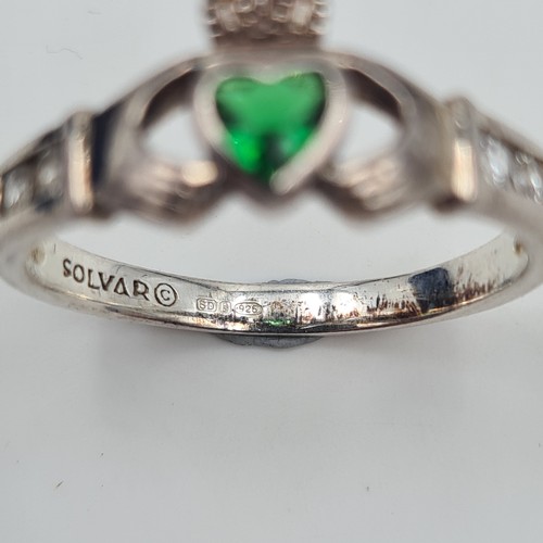 513 - An attractive example of a sterling silver hallmarked Claddagh ring, set with a bright May birth sto... 