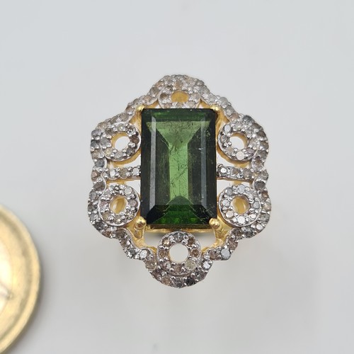 518 - Star Lot: A mesmerising Art Deco inspired silver gilt Green Tourmaline and Diamond ring, featuring a... 