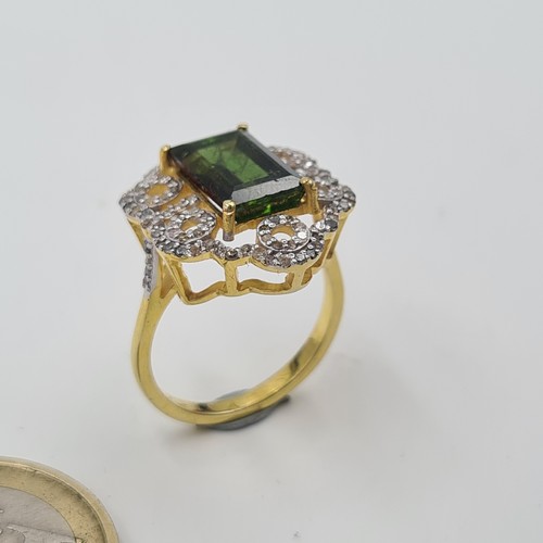 518 - Star Lot: A mesmerising Art Deco inspired silver gilt Green Tourmaline and Diamond ring, featuring a... 