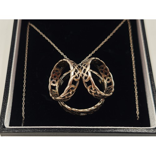 521 - A vintage ring pendant set in sterling silver with three interwoven rings. Together with an antique ... 