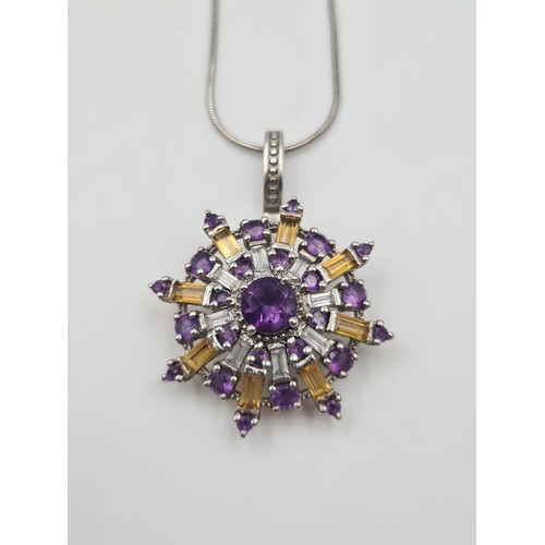 538 - A Gorgeous  articulated circular pendant, set in sterling silver and consisting of Amethyst and Citr... 