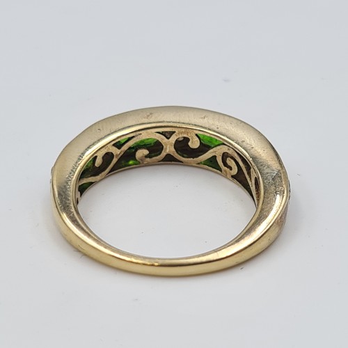 543 - A most attractive vintage four stone Peridot ring, set with Diamond accents on a silver gilt thick b... 