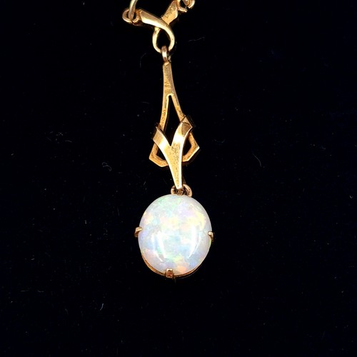 545 - Star Lot : A mesmerising Art Nouveau 9 carat gold drop pendant, set with a generous central Fire Opa... 