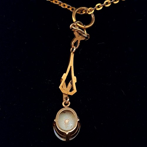 545 - Star Lot : A mesmerising Art Nouveau 9 carat gold drop pendant, set with a generous central Fire Opa... 