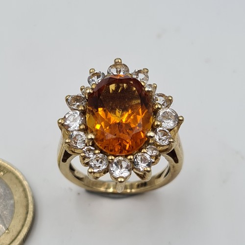 551 - A show stopping and unusual Orange Topaz stone ring, set beautifully with an array of White Sapphire... 