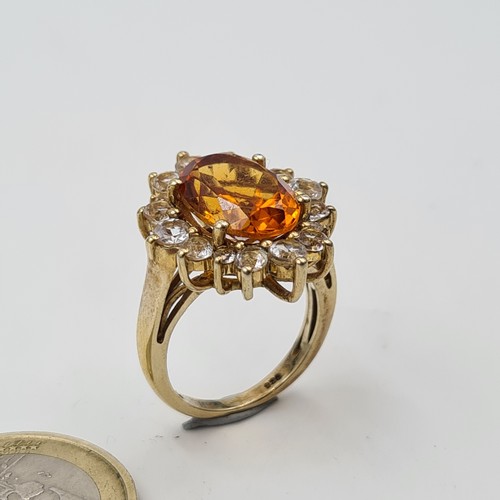 551 - A show stopping and unusual Orange Topaz stone ring, set beautifully with an array of White Sapphire... 