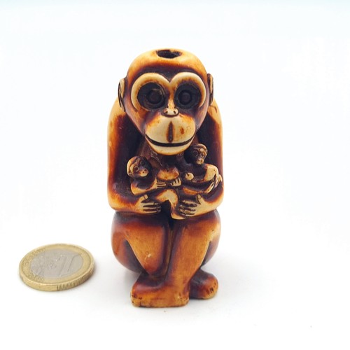 A hand carved antique Japanese Netsuke, in the form of amonkey. Height ...