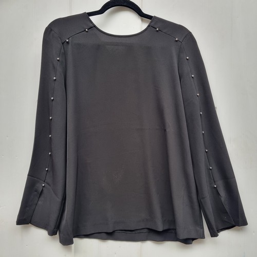 300 - A gorgeous new with tags  black women's blouse by Calvin Klein featuring studded detail to sleeve, w... 