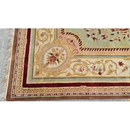 185 - Star Lot : A very large and high quality woolen rug in shades of reds, browns, pinks and greens.  Ve... 